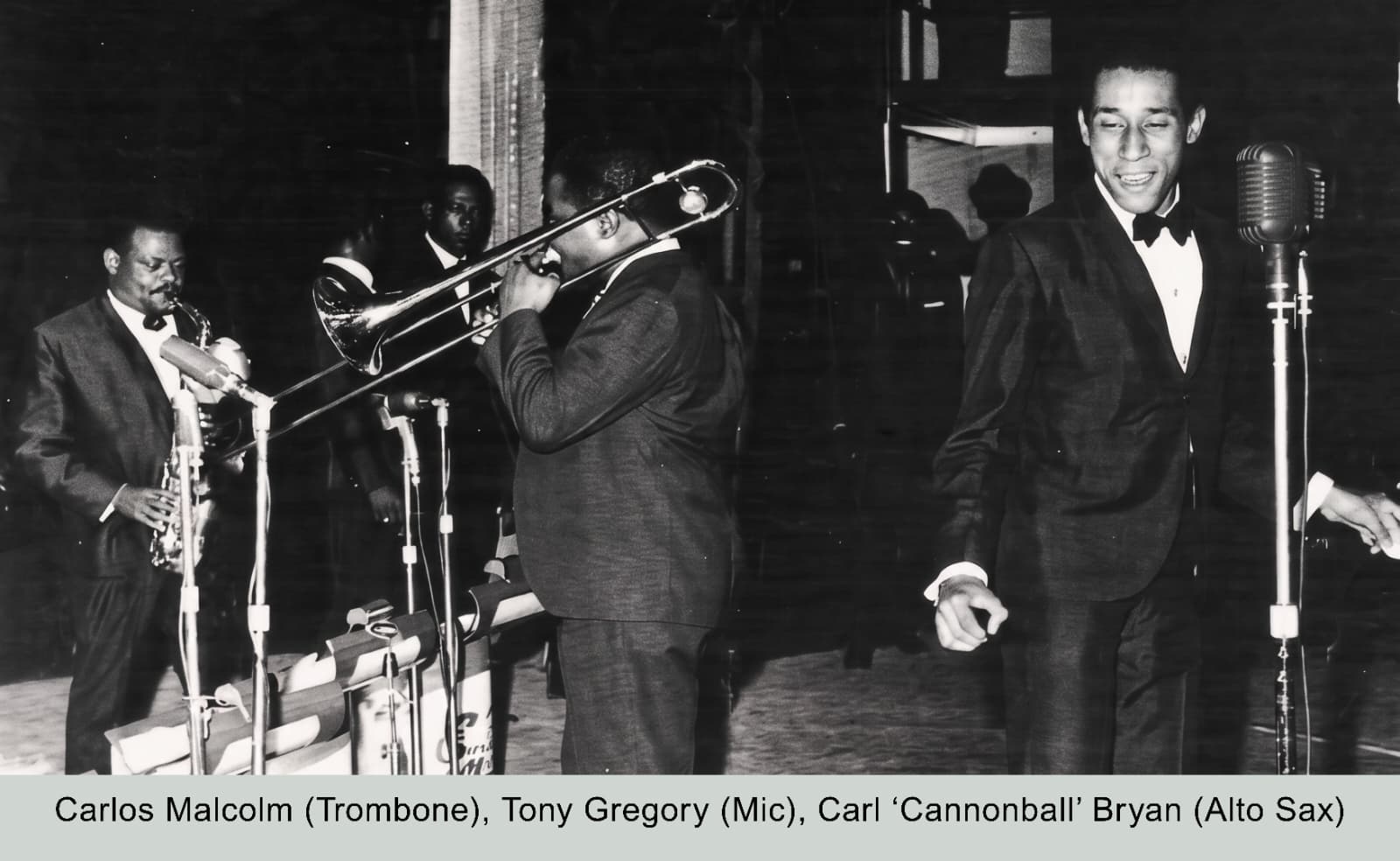 Carlos Malcolm, Tony Gregory, and Carl Cannonball Bryan on stage